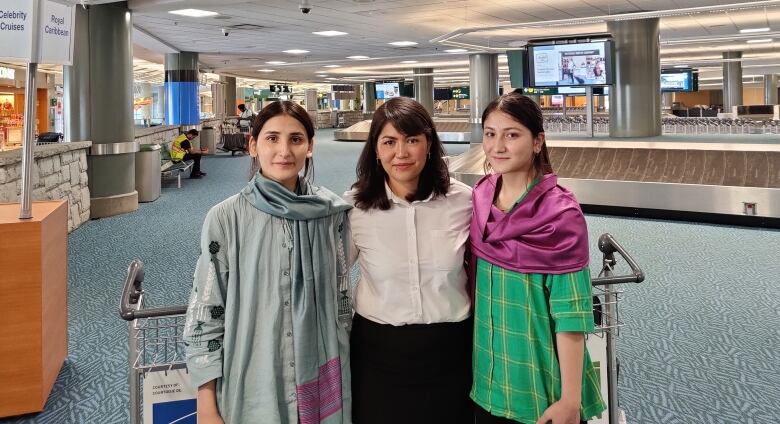 Torpikai Sultani (left) and her sister Zarmina Sultani (right) pose with Friba Rezayee (middle). 