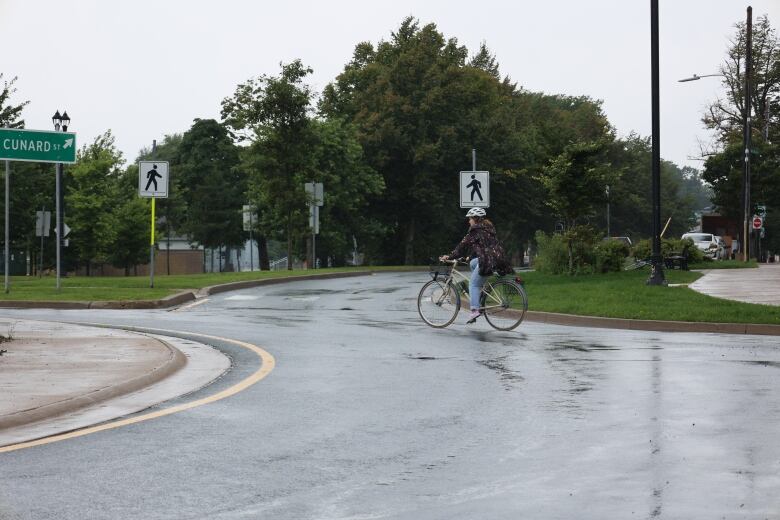 A cyclist is shown riding through a roundabout in Halifax at the corner of Cunard and Agricola streets.