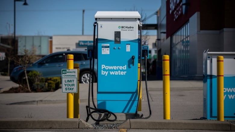 A blue electric vehicle charging station with the words 'Powered by water' and the B.C. Hydro logo.