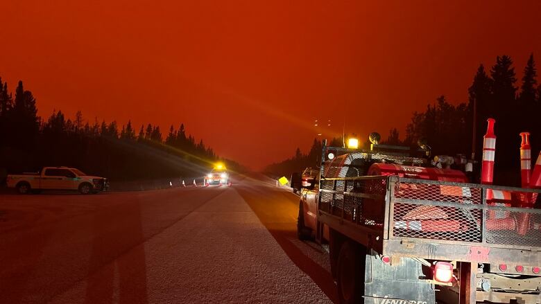 A red sky and vehicles. 