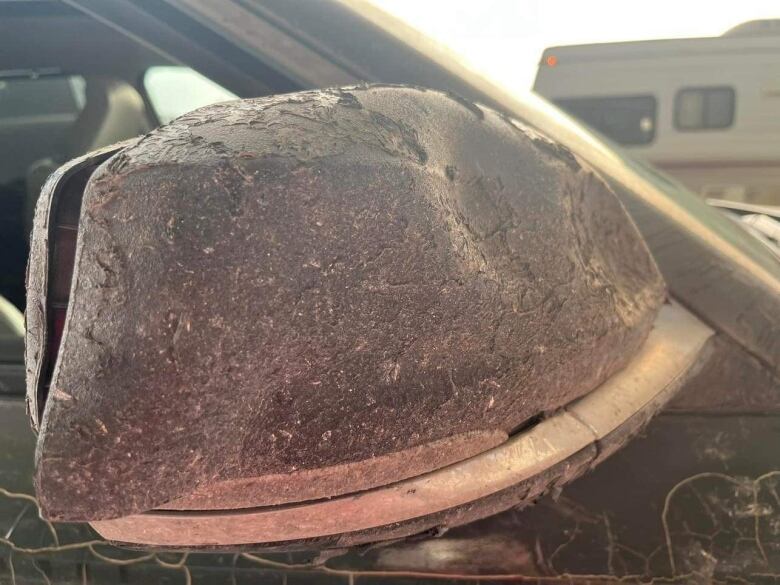 The heat damaged mirror of Hay River resident Lisa Mundy's car. Mundy drove out of Hay River, N.W.T. Sunday at around 6:30 p.m. Her car was damaged between Paradise Gardens and Enterprise, N.W.T. Mundy is now safe in Valleyview, Alberta.