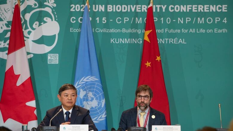 Huang Runqiu, left, President of the COP 15 and Minister of Ecology and Environment of China listens as Steven Guilbeault, Minister of Environment and Climate Change Canada, speaks during a press conference at the COP 15 summit on biodiversity, in Montreal, Saturday, Dec. 17, 2022. 