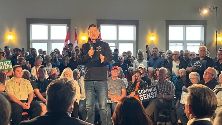 Conservative Leader Pierre Poilievre speaks to a crowded room of supporters at the Cymbria Lions Club in Rustico, P.E.I., on Wednesday night. 