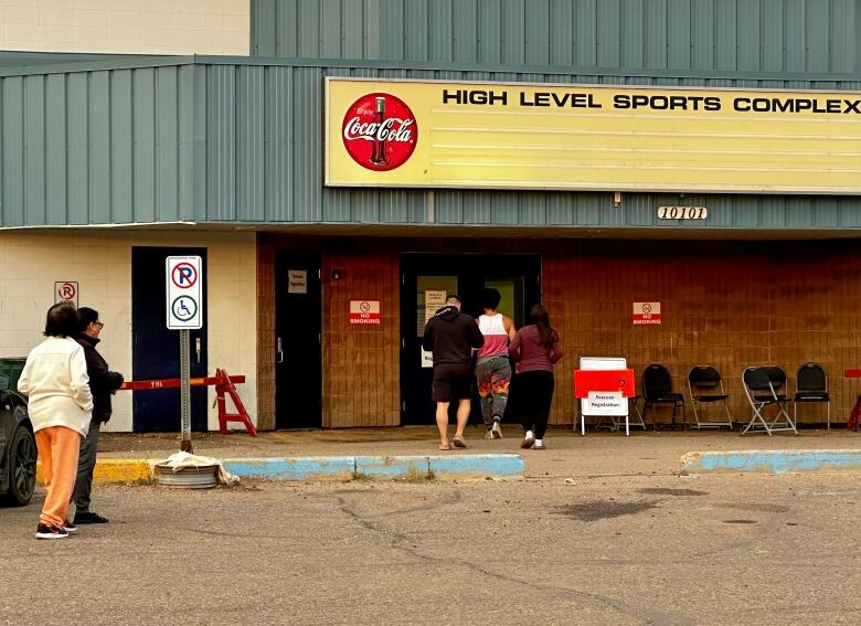 Evacuees from Yellowknife, many of whom have driven all night, head into the evacuation centre in northern Alberta.