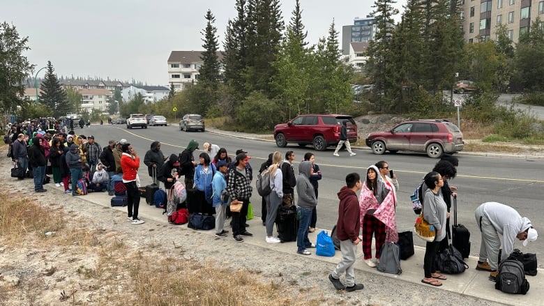 A line up of people on the street.