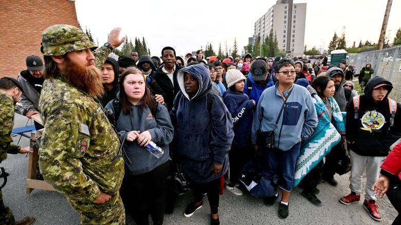 Army man, people in crowd.