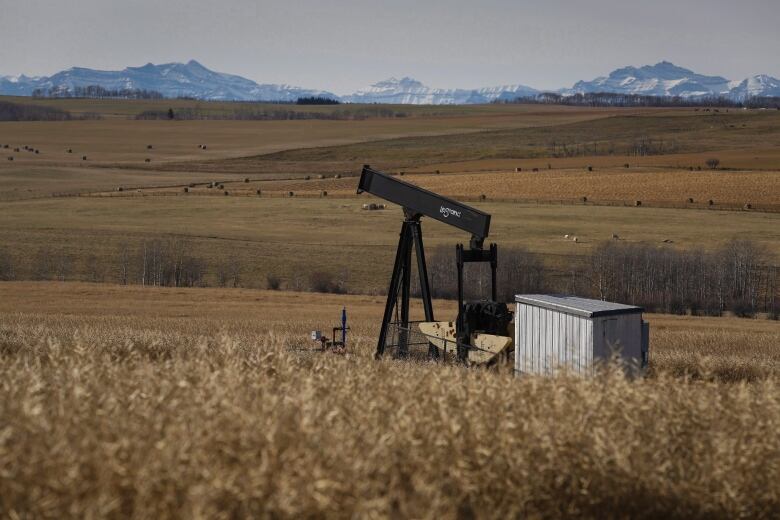 A de-commissioned pumpjack is shown at a well head on an oil and gas installation.