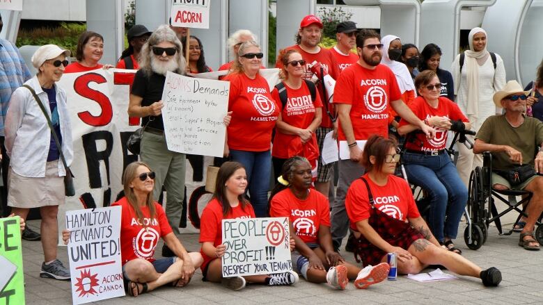 Group of people hold signs