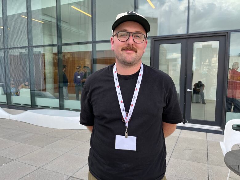 A man poses for a picture outside the Ottawa Art Gallery.