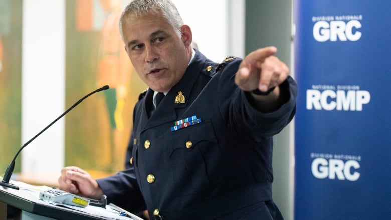 An RCMP officer stands at a podium.