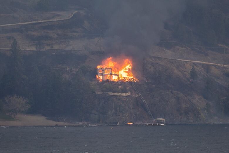 A house is pictured engulfed in flames.