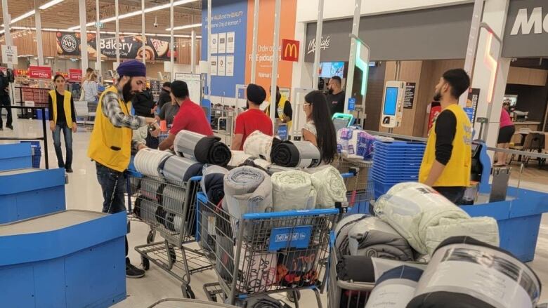 Blankets being purchased at a store.