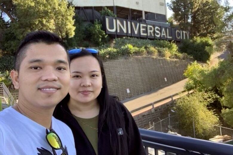 Two people pose for a selfie.