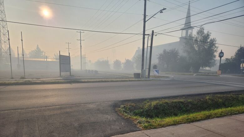 Smoke obscures a street in a city.