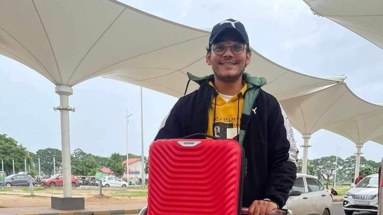 Man with suitcases at airport in India