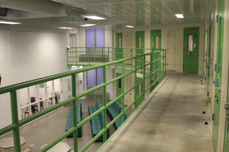 A jail with cells, green doors