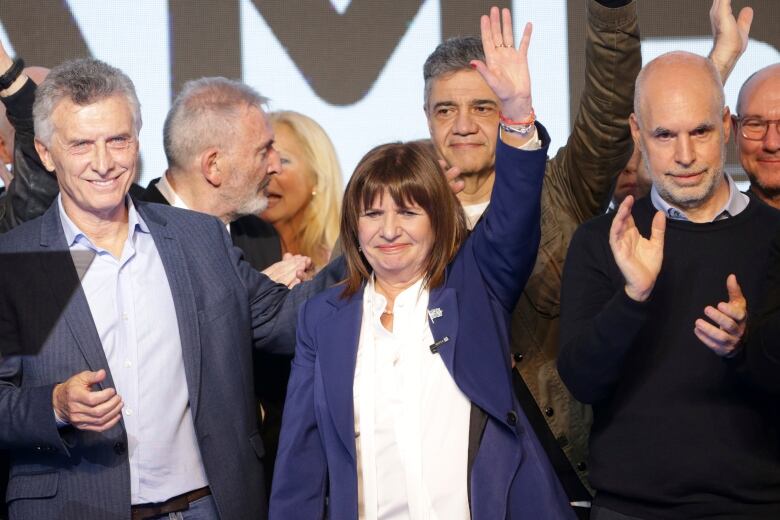 Presidential candidate Patricia Bullrich (center), former hopeful Horacio Rodrguez Larreta (right), with the United for Change coalition, and Argentina's former president Mauricio Macri (left) celebrate at their campaign headquarters after polling stations closed during primary elections in Buenos Aires, Argentina on Aug. 13, 2023.