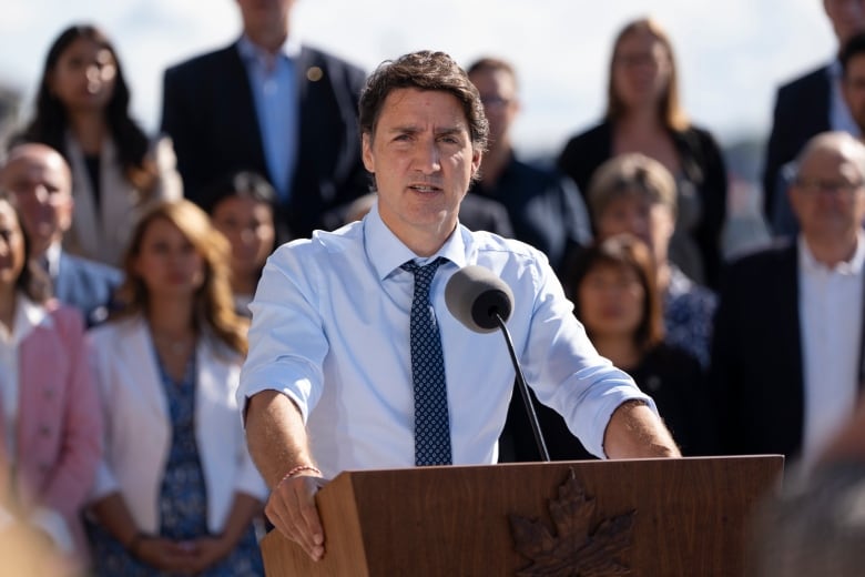 Prime Minister Justin Trudeau speaks to reporters as cabinet members look on during the Liberal cabinet retreat in Charlottetown, P.E.I. on Wednesday, August 23, 2023.