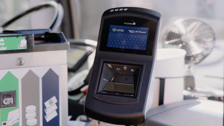 A black machine with a screen reading 'Umo' and 'B.C. Transit.'