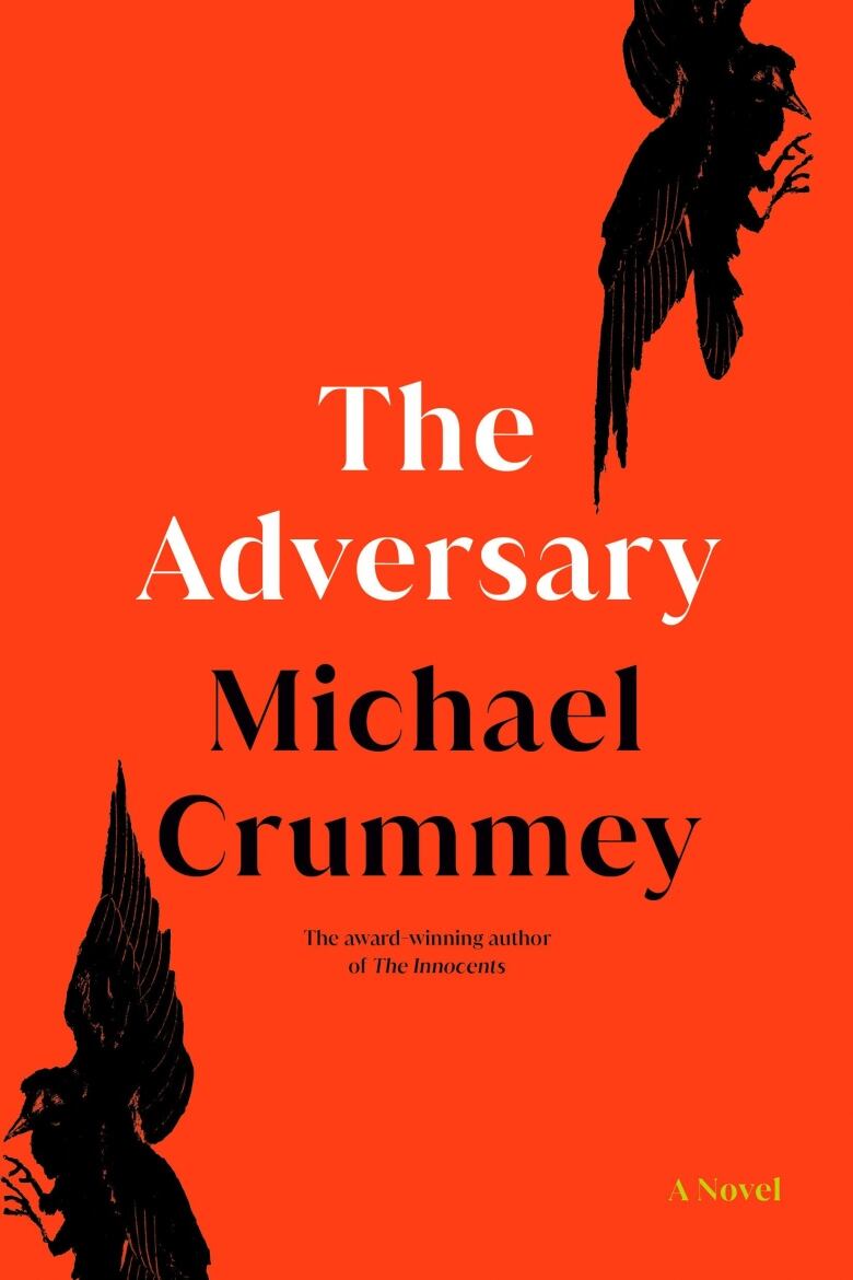 The Adversary by Michael Crummey. An orange book cover with two black birds flying on either side.