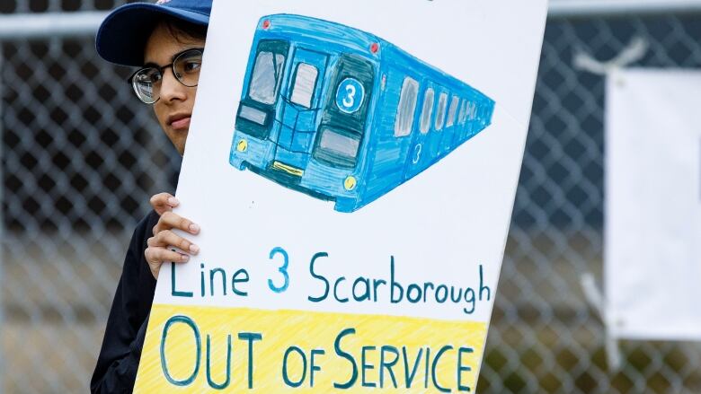 A transit user is photographed in Scarborough, on Aug. 23, 2023. 