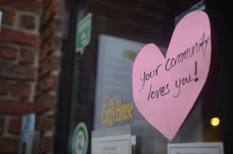 People showed support for Sharif Rahman's family in the days following his assault, and later his death, with flowers and messages on his storefront. 