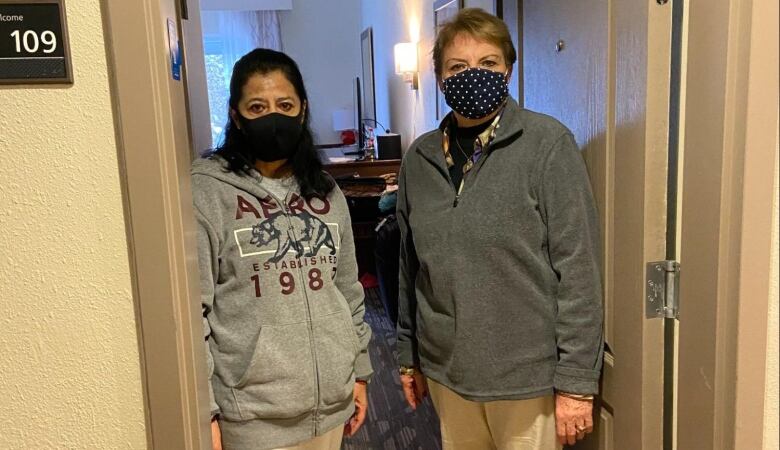 Two women wearing masks.