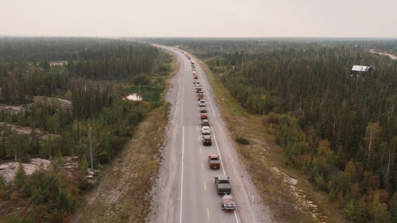 Cars are seen in a line on a highway.