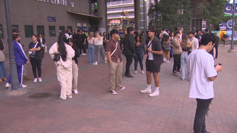 Fans mill around outside a downtown arena.