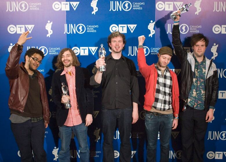 Five musicians celebrate winning a Juno Award.