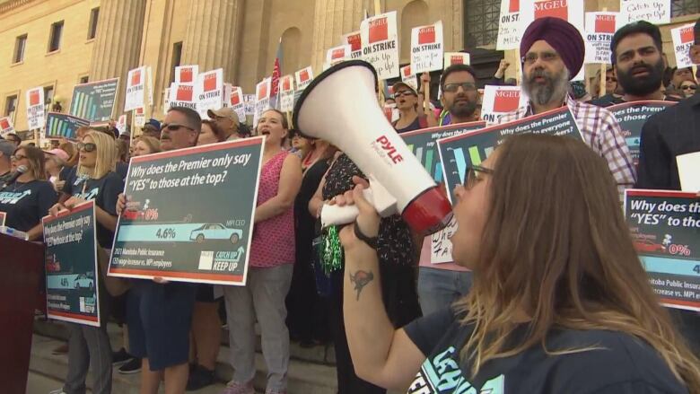 Crowds gather on the steps of a government legislature as part of an ongoing strike.