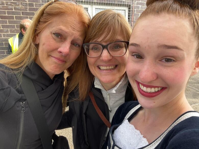 The women are seen smiling with tears of happiness. 