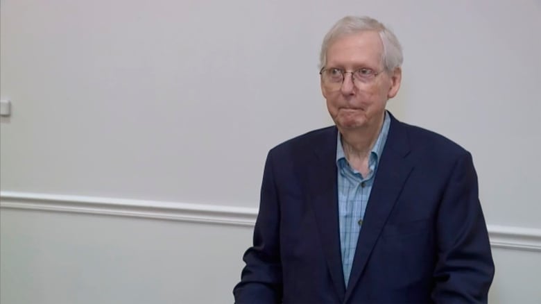 A man freezes at a podium. 