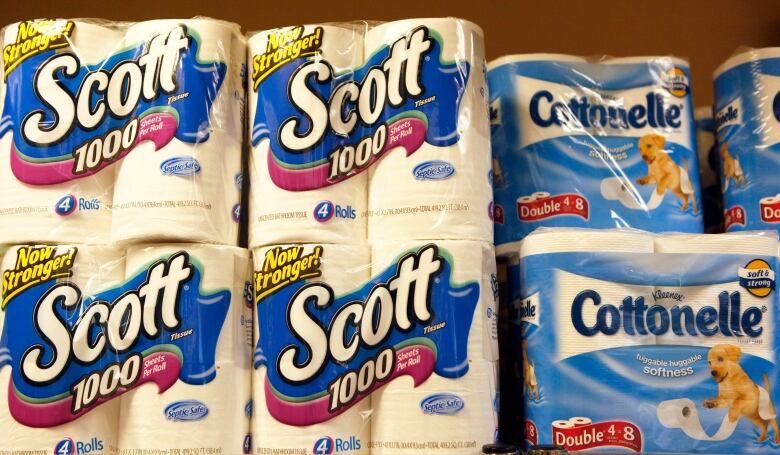 Two tissue brands marked 'Scott' and 'Cottonelle' on a store shelf.