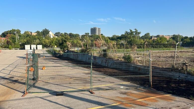 Photo of a fenced in area in a parking lot