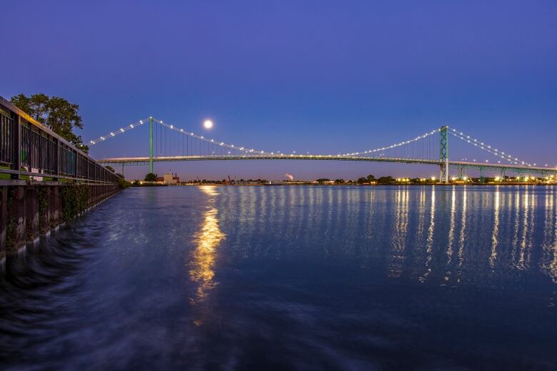 Super blue moon is photographed above the Ambassador Bridge linking Windsor, Ont., and Detroit, Mi., Aug. 30, 2023.