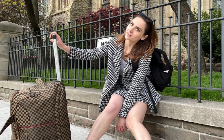 Ivanna Chornenka Osovska sitting in front of a church railing in Toronto.