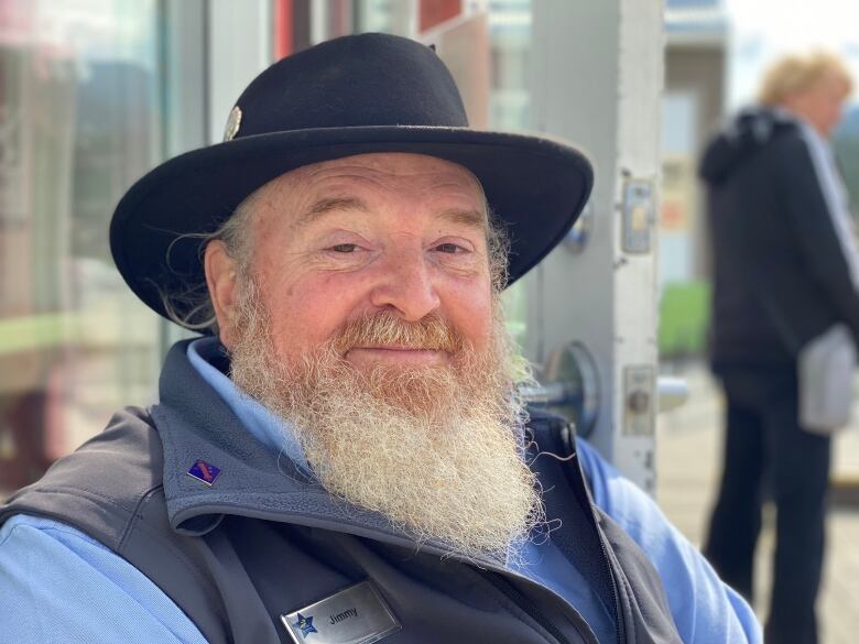 A man with a big white beard smiles for the camera.