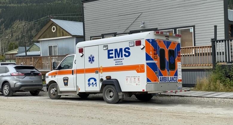 An ambulance parked infront of a building.