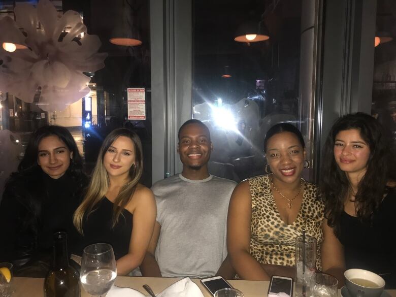 Several people sit at a restaurant table