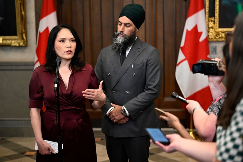 NDP MP Jenny Kwan is joined by NDP leader Jagmeet Singh as she speaks to reporters  in the Foyer of the House of Commons on Parliament Hill in Ottawa, on Monday, May 29, 2023. 