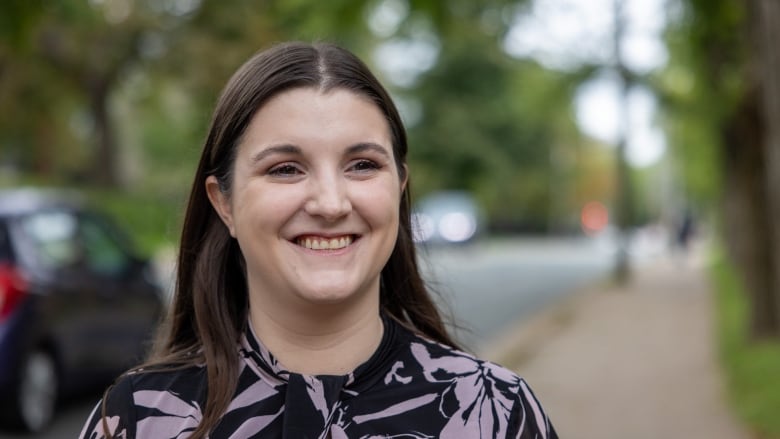 A woman is smiling on a street in Halifax, N.S.