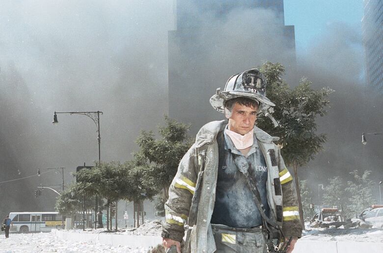 A New York City firefighter walks away from Ground Zero after the collapse of the Twin Towers.