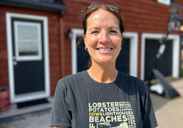 Smiling woman in grey T-shirt. 