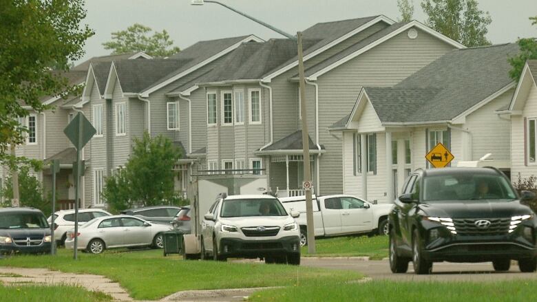 A small traffic jam in a residential neighbourhood.