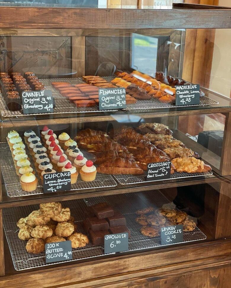 A glass display case filled with different desserts and pastries.