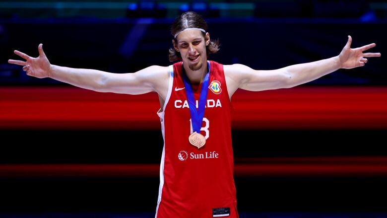 Kelly Olynyk #13 of Canada poses with his bronze medal after the FIBA Basketball World Cup 3rd Place game victory over the United States at Mall of Asia Arena on September 10, 2023 in Manila, Philippines. 