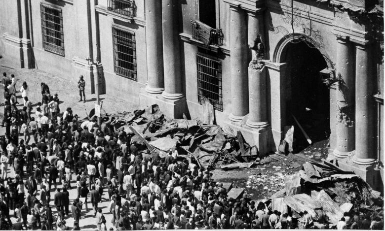 Aftermath of an explosion in South America in the early 1970s outside a building.