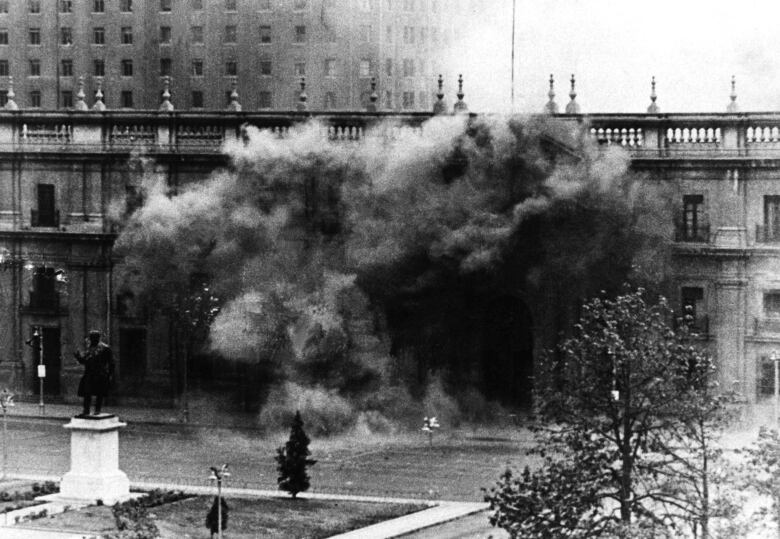 Historical photo of the Chilean presidential palace getting bombed. 