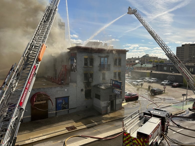 Firefighters battle a blaze at the 120-year-old Windsor Hotel in downtown Winnipeg Wednesday morning